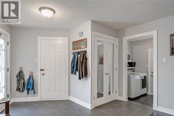 Entryway with doors to a laundry room and a double-glass door closet. - 3163 Barwell Road, Mississauga