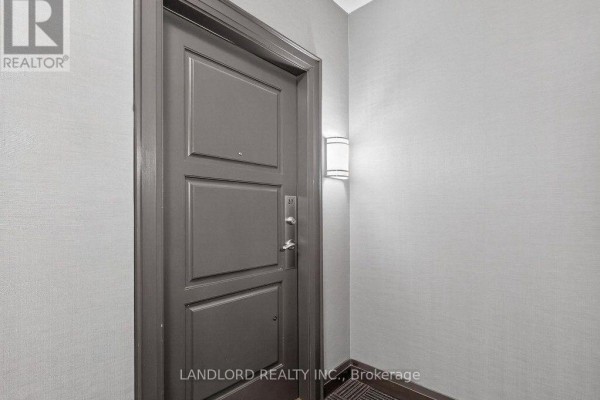 Close-up of a dark grey apartment entrance door with a silver number 317. - 317 - 9506 Markham Road, Markham