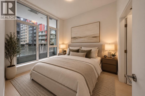 Bedroom with a queen-sized bed, nightstands, and a large window overlooking the city. - 317 3438 Sawmill Crescent, Vancouver