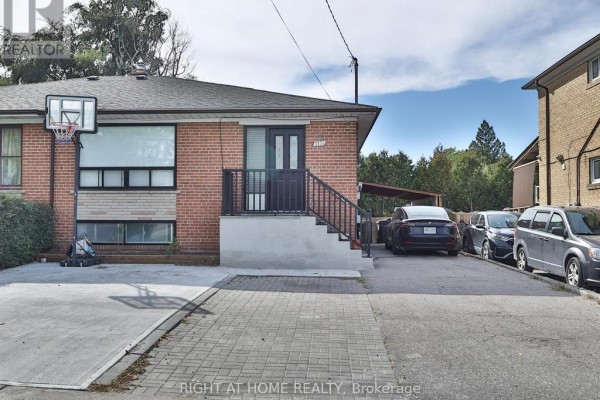 Front exterior of a brick bungalow with a basketball hoop and driveway. - 3174 Weston Road, Toronto