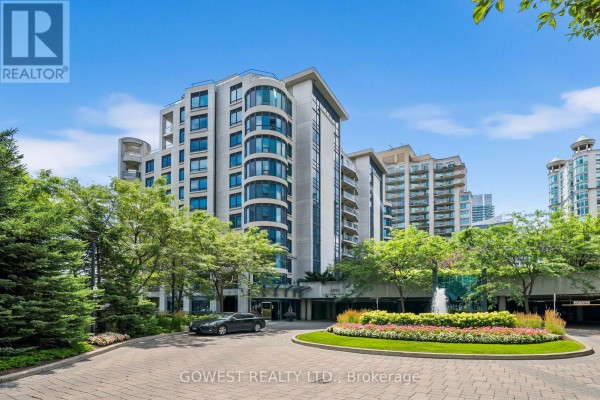Circular driveway with stone paving, garden island, and building entrances. - 318 - 2095 Lake Shore Boulevard W, Toronto