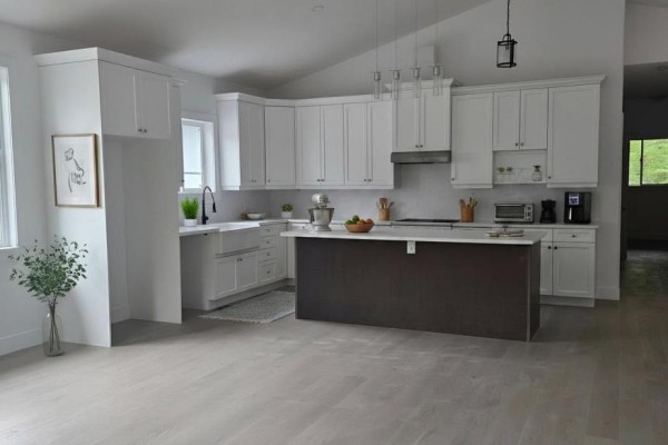 White kitchen with a dark brown island, white countertops, and subway tile backsplash. - 3183 Cove Avenue, Innisfil