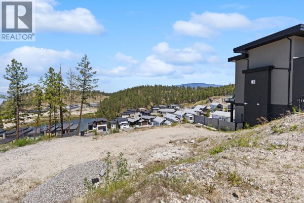 Panoramic view of a lake, hills, and a neighborhood of modern houses under a blue sky. - 3183 Hilltown Drive, Kelowna