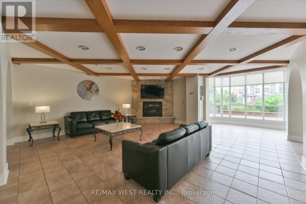 Large apartment building lobby with tiled flooring, arched entrances, and seating areas. - 319 - 7373 Martin Grove Road, Vaughan