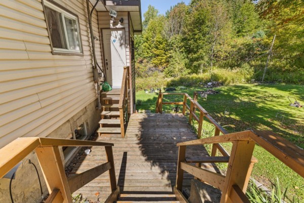 Wooden deck with railings leading to stairs and the side of a duplex. - 31a-31b Ch. Du Boisé, Val Des Monts