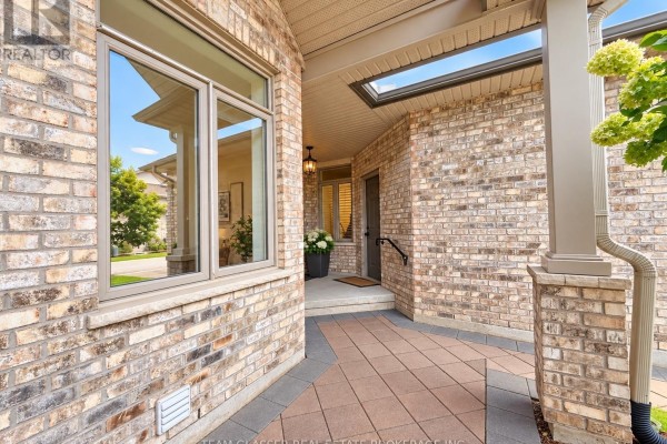 Covered entryway with brick walls, a skylight, and a large window. - 32 - 44 Edgevalley Road, London East