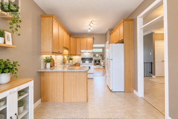 Kitchen with light wood cabinets, granite countertops, and stainless steel appliances. - 32 - 44 Edgevalley Road, London East