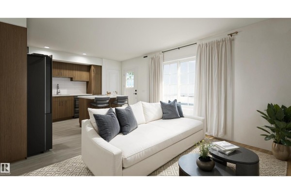 Bedroom with a king-size bed, light wood floors, and natural light from a large window. - #32 17319 5 St Ne, Edmonton
