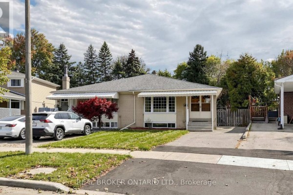 Side view of a light brick bungalow with a driveway, mature trees, and neighboring houses. - 32 Cairnside Crescent, Toronto