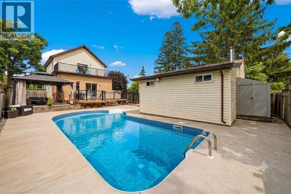 Aerial view of a property featuring a swimming pool, deck, and gazebo. - 32 Clench Avenue, Brantford