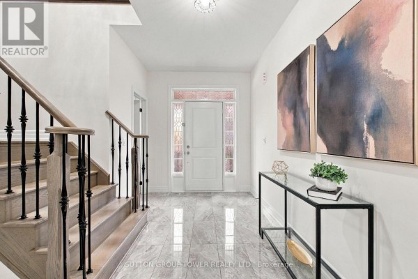 Foyer with white door, stained glass sidelights, marble tile floor, and modern console table. - 32 Cyprus Glen, East Gwillimbury