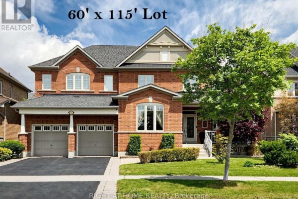 Exterior view of a large, two-story brick house with a two-car garage. - 32 Lake Forest Drive, Richmond Hill