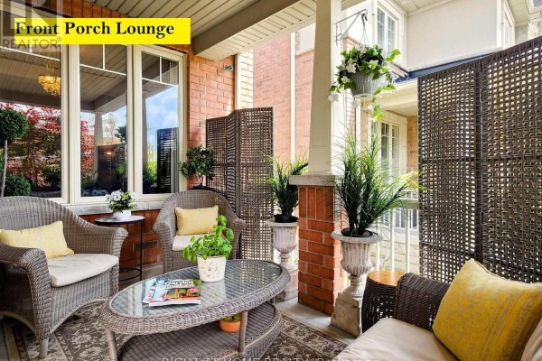 Covered front porch with wicker furniture, planters, and woven privacy screens. - 32 Lake Forest Drive, Richmond Hill