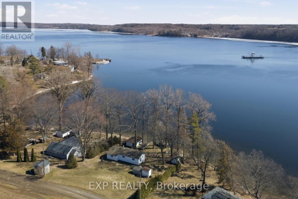 Aerial view of waterfront property with buildings and ferry boat - 32 Quinte View Road Greater Napanee