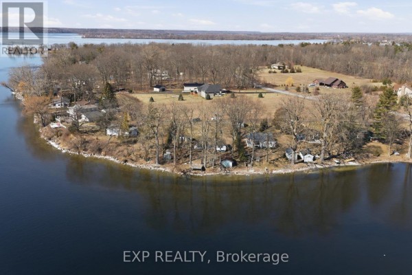 Lakefront property with several homes and trees along the water - 32 Quinte View Road Greater Napanee
