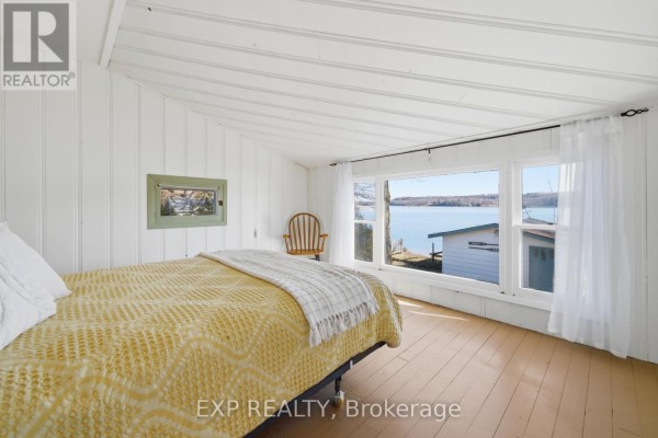 Bedroom with lake view and boat house - 32 Quinte View Road Greater Napanee