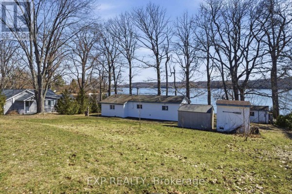 Exterior view of property with sheds and lake - 32 Quinte View Road Greater Napanee