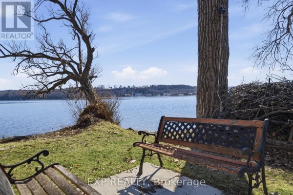 Lake view with park bench and trees - 32 Quinte View Road Greater Napanee