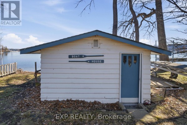 Boat house with blue door and dock - 32 Quinte View Road Greater Napanee