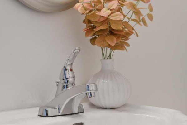 White ceramic sink with chrome faucet and oval mirror - 32 Quinte View Road Greater Napanee
