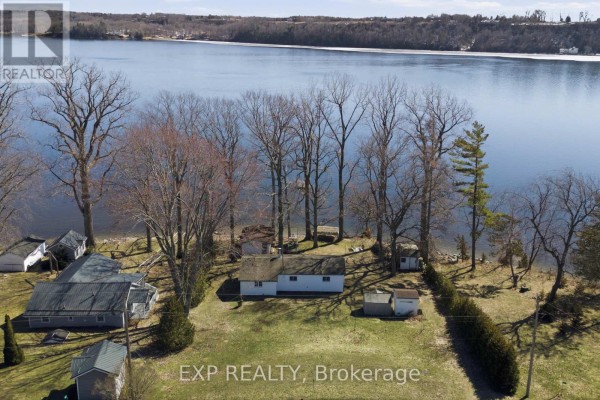 Lakefront property with white house and outbuildings - 32 Quinte View Road Greater Napanee
