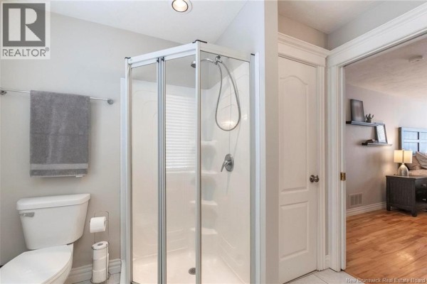 Spacious bathroom with jetted tub, separate shower, and neutral tile flooring - 32 Vanessa Court, Riverview