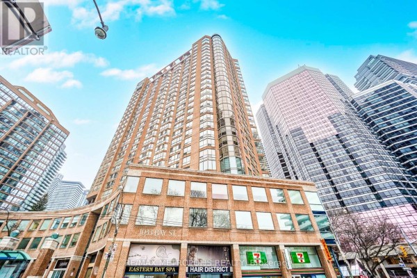 Exterior of a modern high-rise building with retail storefronts. - 320 - 1033 Bay Street, Toronto