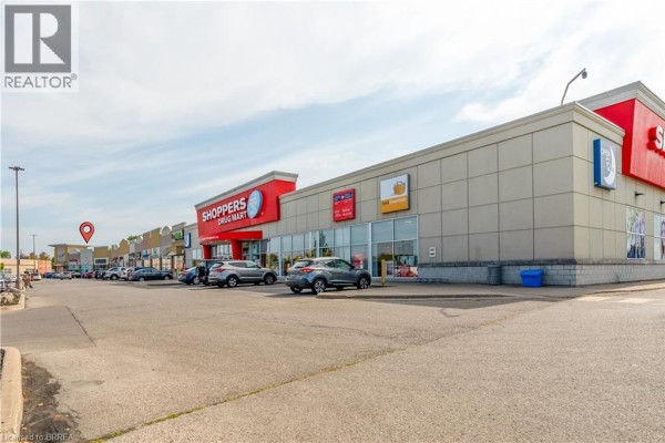View of adjacent shopping area with Shoppers Drug Mart and other retail stores. - 320 Colborne Street W Unit# 13, Brantford