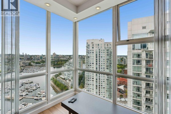 Interior corner with floor-to-ceiling windows offering panoramic city and marina views. - 3202 193 Aquarius Mews, Vancouver