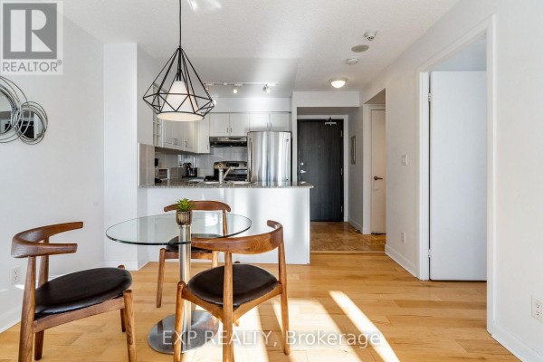 View of kitchen, dining area, and hallway leading to apartment entrance. - 3205 - 210 Victoria Street, Toronto