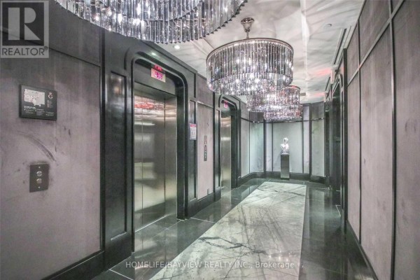 Elevator lobby with polished floors, mirrored walls, and ornate crystal chandeliers. - 3205 - 88 Blue Jays Way, Toronto
