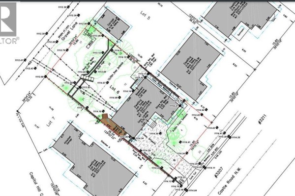 Architectural drawing showing lot lines, house outlines, dimensions, and landscape features for 3207 Castle Road NW. - 3207 Castle Road Nw, Calgary