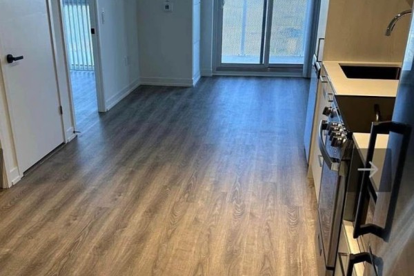Interior view showing a small kitchen area with gray wood-look flooring. - 3208 - 195 Commerce Street, Vaughan