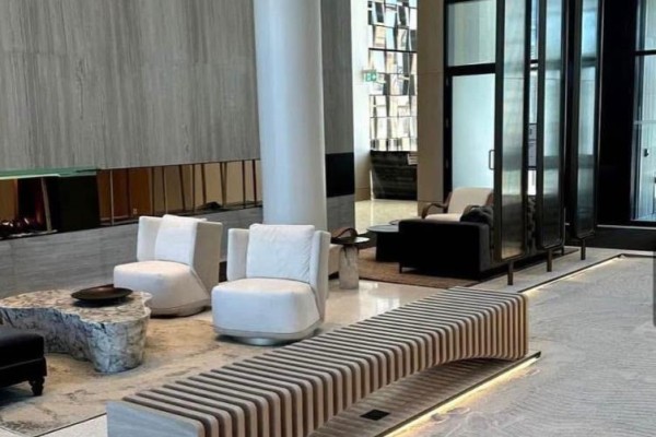 Apartment building lobby with modern furniture, fireplace, and decorative walls. - 3208 - 195 Commerce Street, Vaughan