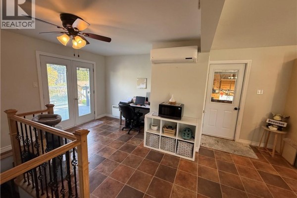 Interior hallway with light beige walls, tile flooring, and double glass doors leading outside. - 321 Route 134, Petit Rocher Nord