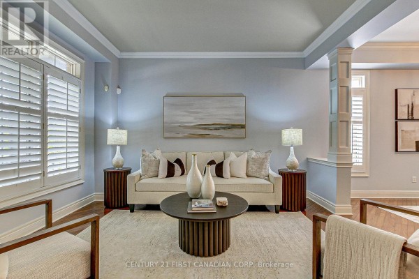 Living room with a sofa, armchairs, coffee table, and plantation shutters on windows. - 322 Chambers Place, London North