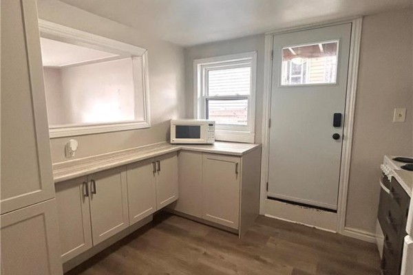 Kitchen area featuring white appliances, light cabinetry, and countertop space - 322 Edwin Street Unit# 1, Kitchener