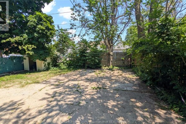 Backyard area with a concrete pad and wooden fence. - 322 Partington Unit# Upper, Windsor