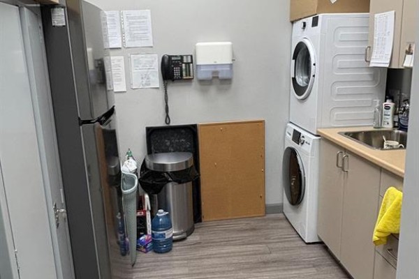 Closet area with dark cabinets, open shelving, hangers, and a grey floor mat. - 323 Caradoc Street S, Strathroy Caradoc