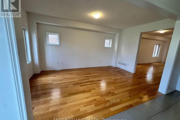 Dining room with hardwood floors, white walls, and a view into another room. - 324 Moody Street, Southgate