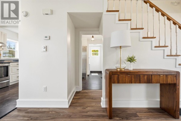 Wooden deck with lattice railing attached to the side of the white clapboard house. - 324 Wentworth Road, Windsor