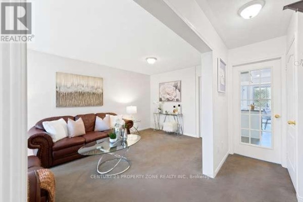 Leather sofa and glass coffee table in living room - 3242 Tortola Court Mississauga