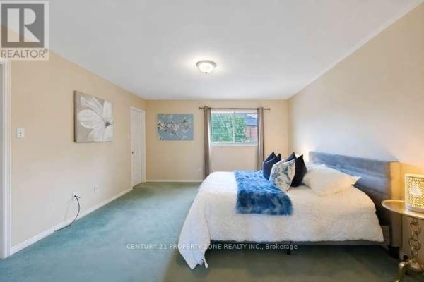 Bedroom with king size bed, blue & white pillows, and blue throw - 3242 Tortola Court Mississauga