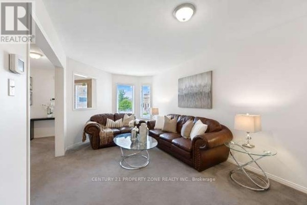 Brown leather sofas and glass coffee table in living room - 3242 Tortola Court Mississauga