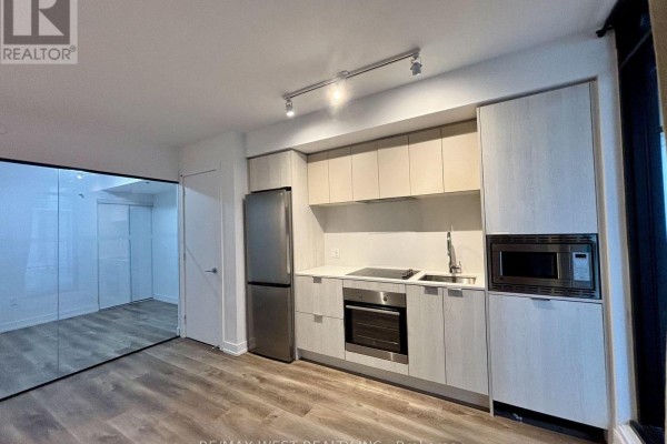Apartment kitchen with light wood cabinets, stainless steel appliances and a sink. - 325 - 1 Jarvis Street, Hamilton