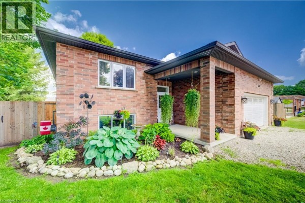 Front view of a red brick bungalow with a well-maintained garden and porch. - 325 Mill Street, Palmerston