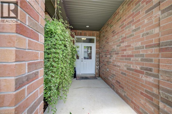 Close-up of the covered walkway leading to the front door of a brick house. - 325 Mill Street, Palmerston