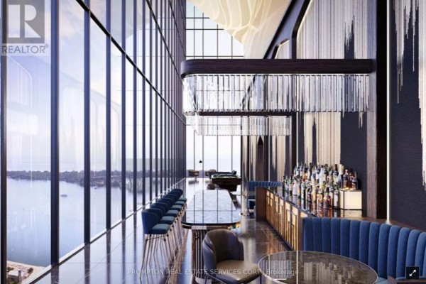 Indoor swimming pool with lounge chairs and city views through floor-to-ceiling windows. - 326 - 3 Concord Cityplace Way, Toronto