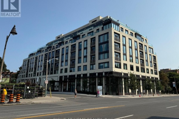 Exterior view of a multi-story apartment building with glass and beige panels. - 326 - 3 Strathgowan Avenue, Toronto
