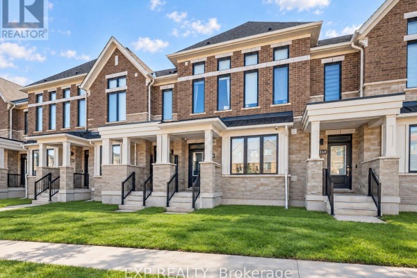 Exterior view of townhouse with brick facade, front steps, and snow-covered ground - 3266 Sixth Line, Oakville